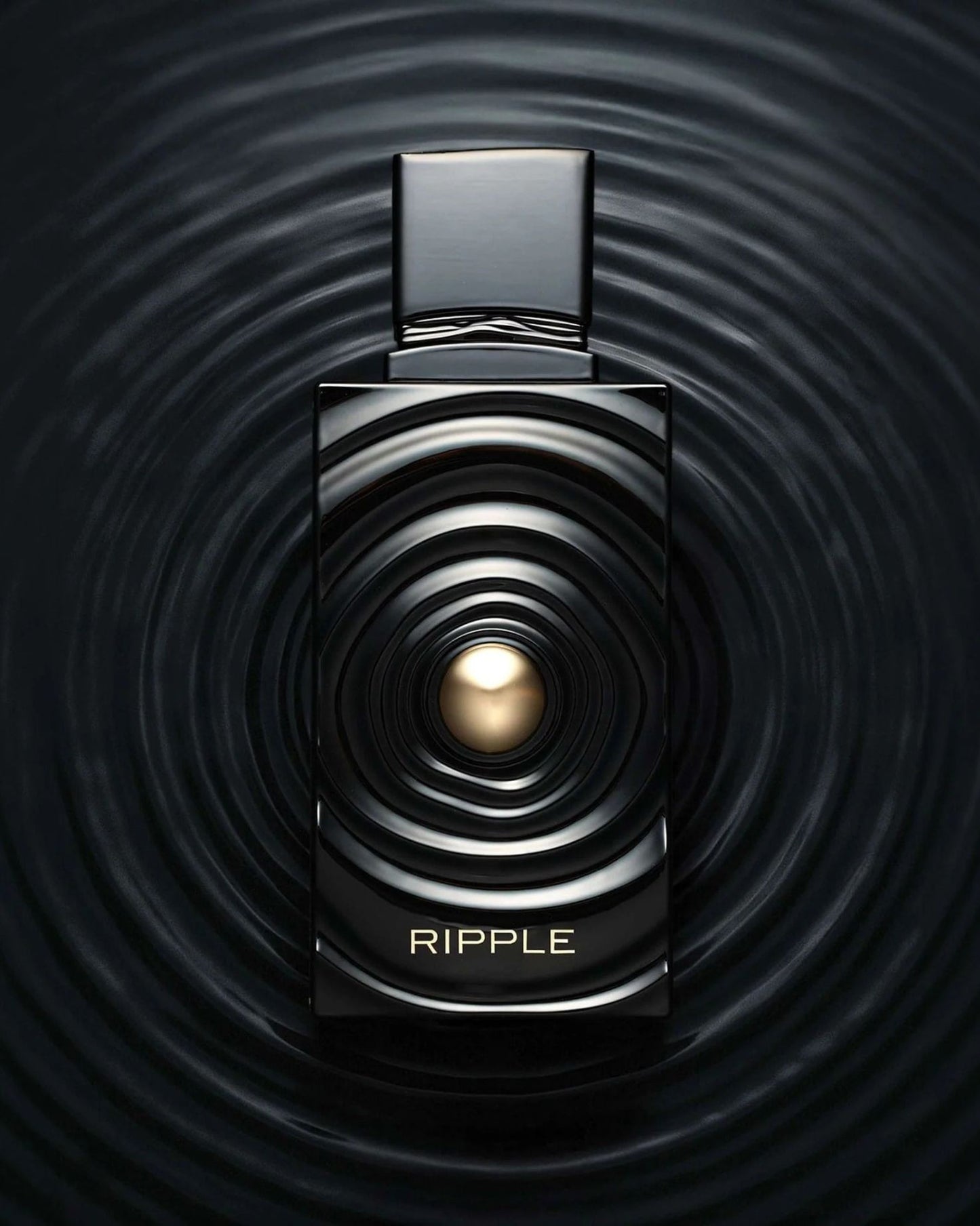 Creative product photography of Ripple edp french avenue luxury fragrance, showing the black and gold bottle seamlessly blending into a dark liquid ripple background.