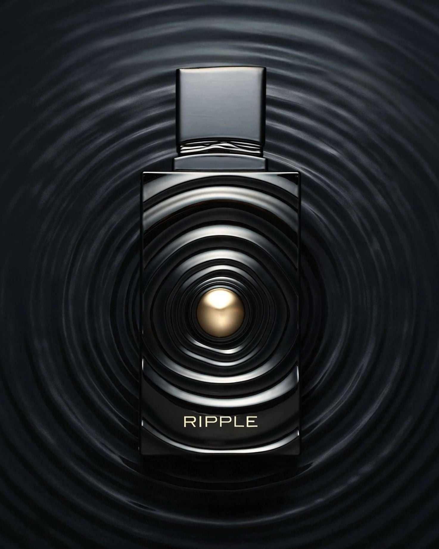 Creative product photography of Ripple edp french avenue luxury fragrance, showing the black and gold bottle seamlessly blending into a dark liquid ripple background.
