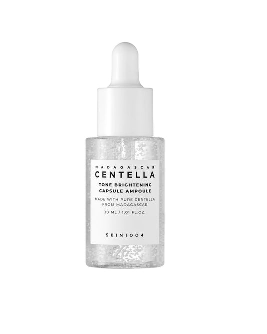 Clear glass dropper bottle of SKIN 1004 Madagascar Centella Tone Brightening Capsule Ampoule. The label indicates the size is 30 mL / 1.01 fl. oz.