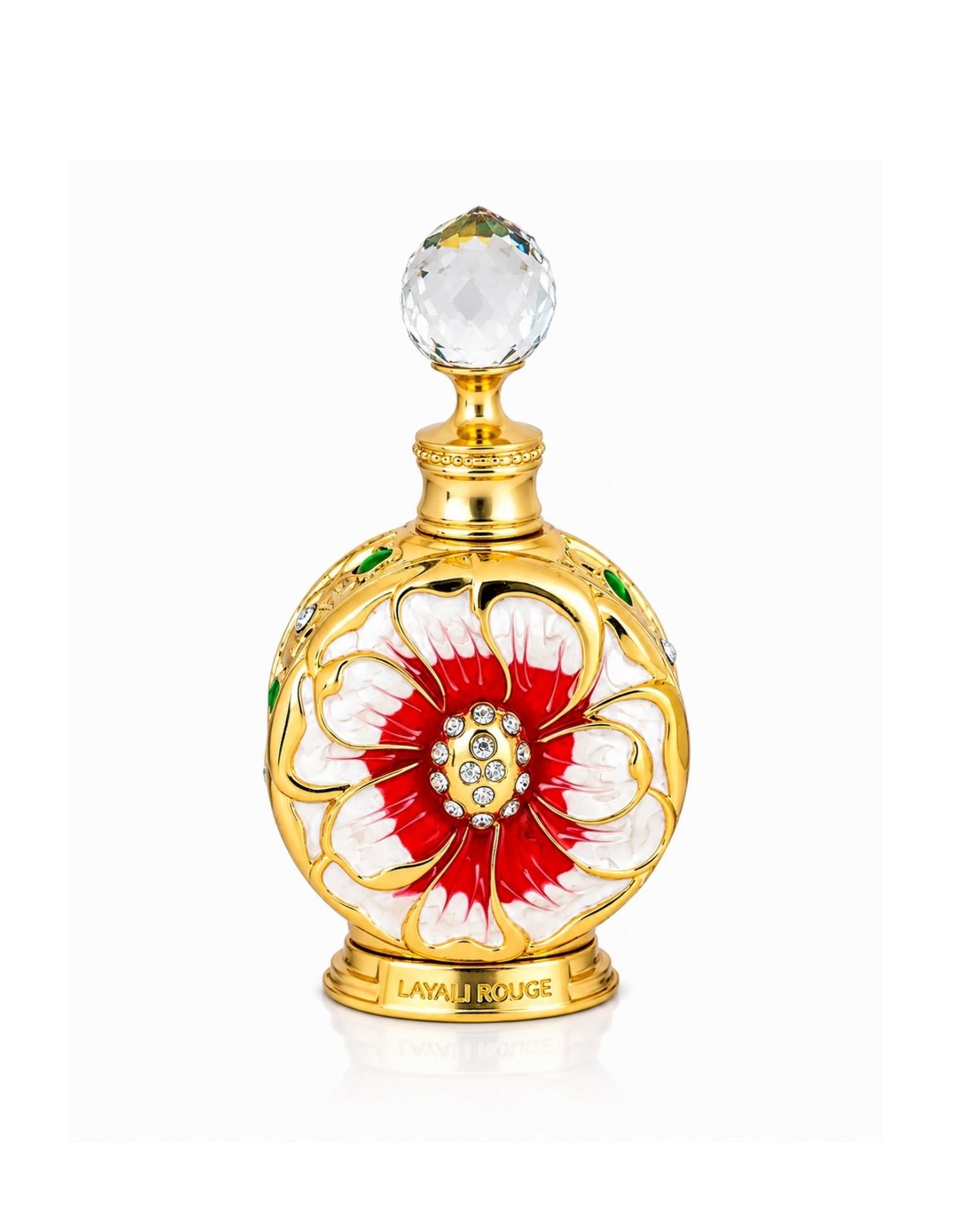Swiss Arabian Layali Rouge concentrated perfume oil in an ornate gold bottle with a red and white floral enamel design and crystal stopper.