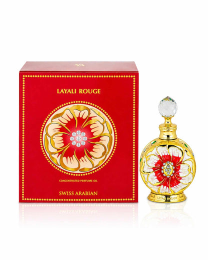 Swiss Arabian Layali Rouge concentrated perfume oil bottle standing next to its red and gold decorative packaging box.