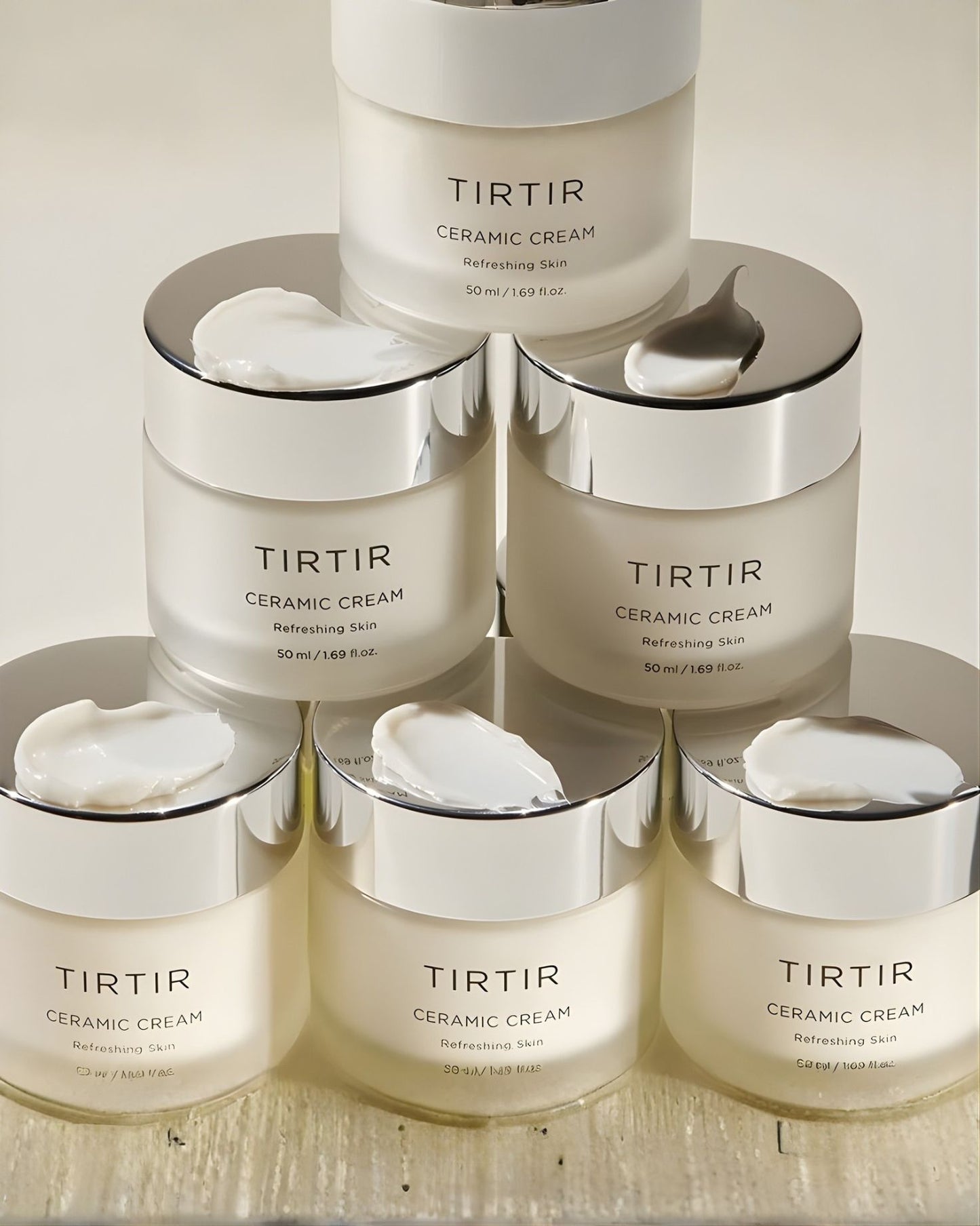 Simple, clean product shot of the TIRTIR Ceramic Cream jar (50 ml), labeled "Refreshing Skin," with a frosted white glass container and silver metallic cap.