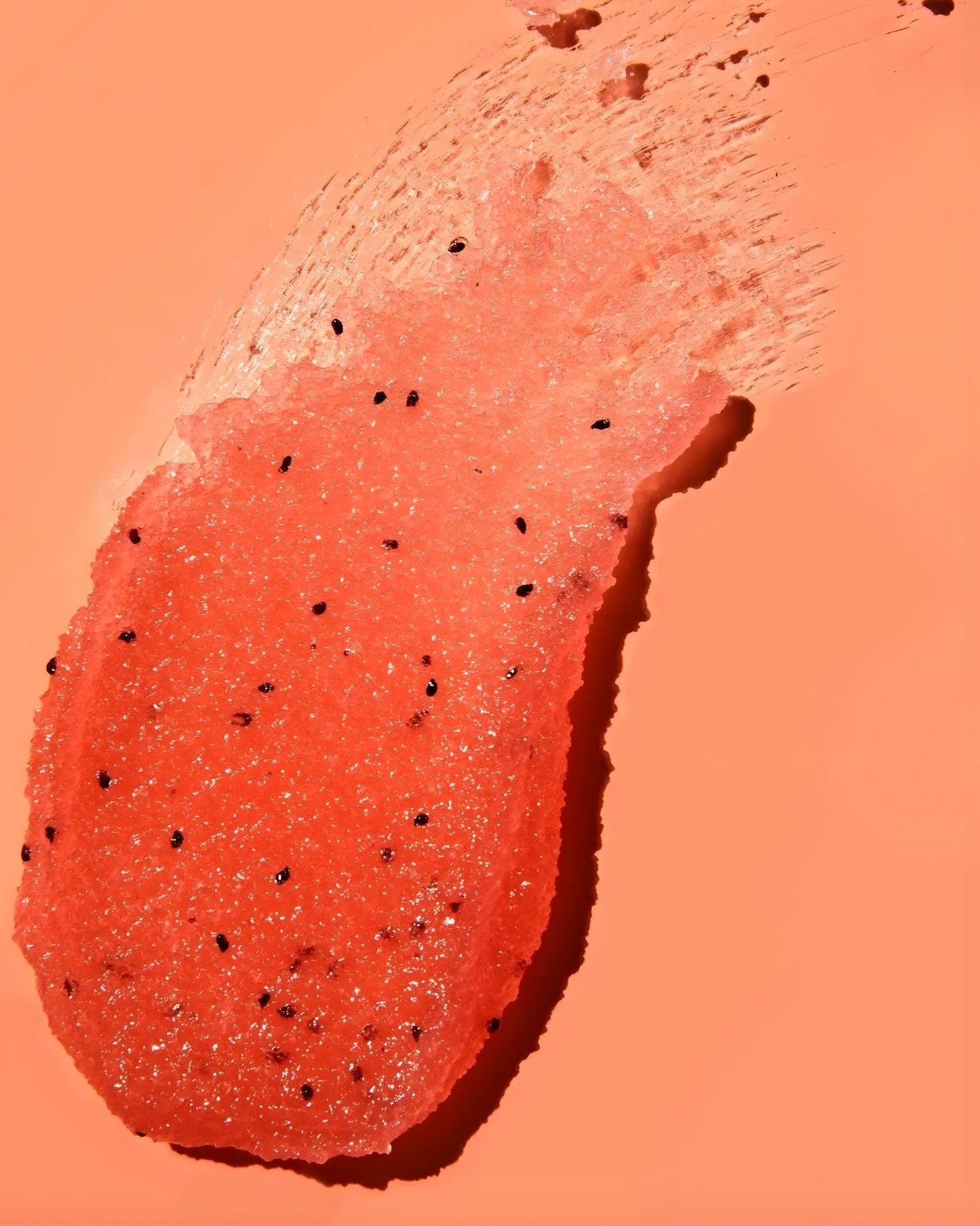 Close-up swatch of Tree Hut Watermelon Shea Sugar Scrub showing sugar crystals and texture.