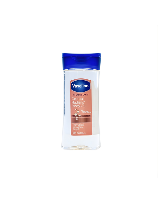 A clear plastic bottle of Vaseline Intensive Care Cocoa Radiant Body Oil. The product has a blue flip-top cap, and the label highlights '100% PURE COCOA BUTTER' and promises 'vitalizing body oil for healthy glowing skin,' isolated against a white background.